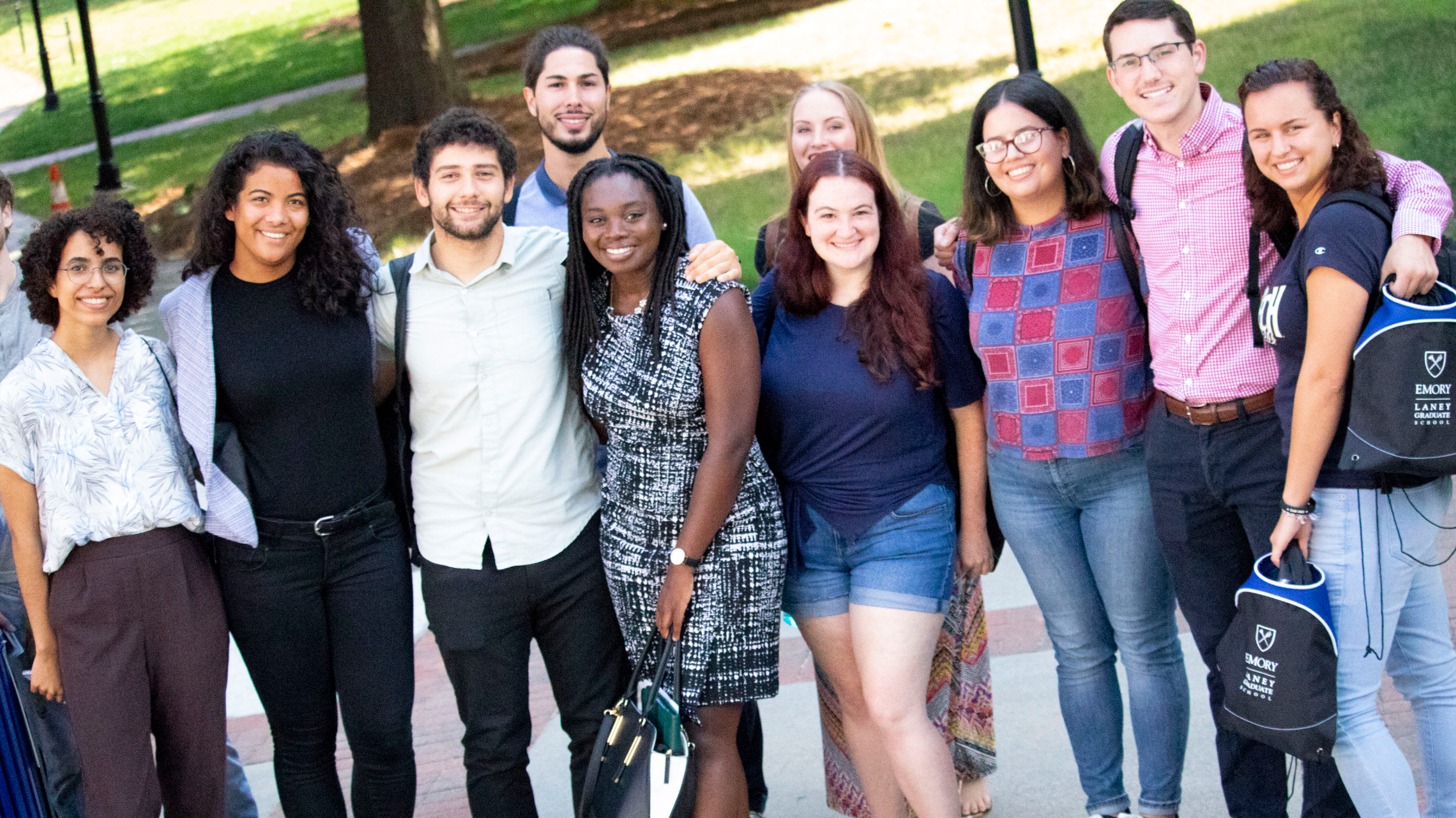 Students stand and smile in a group