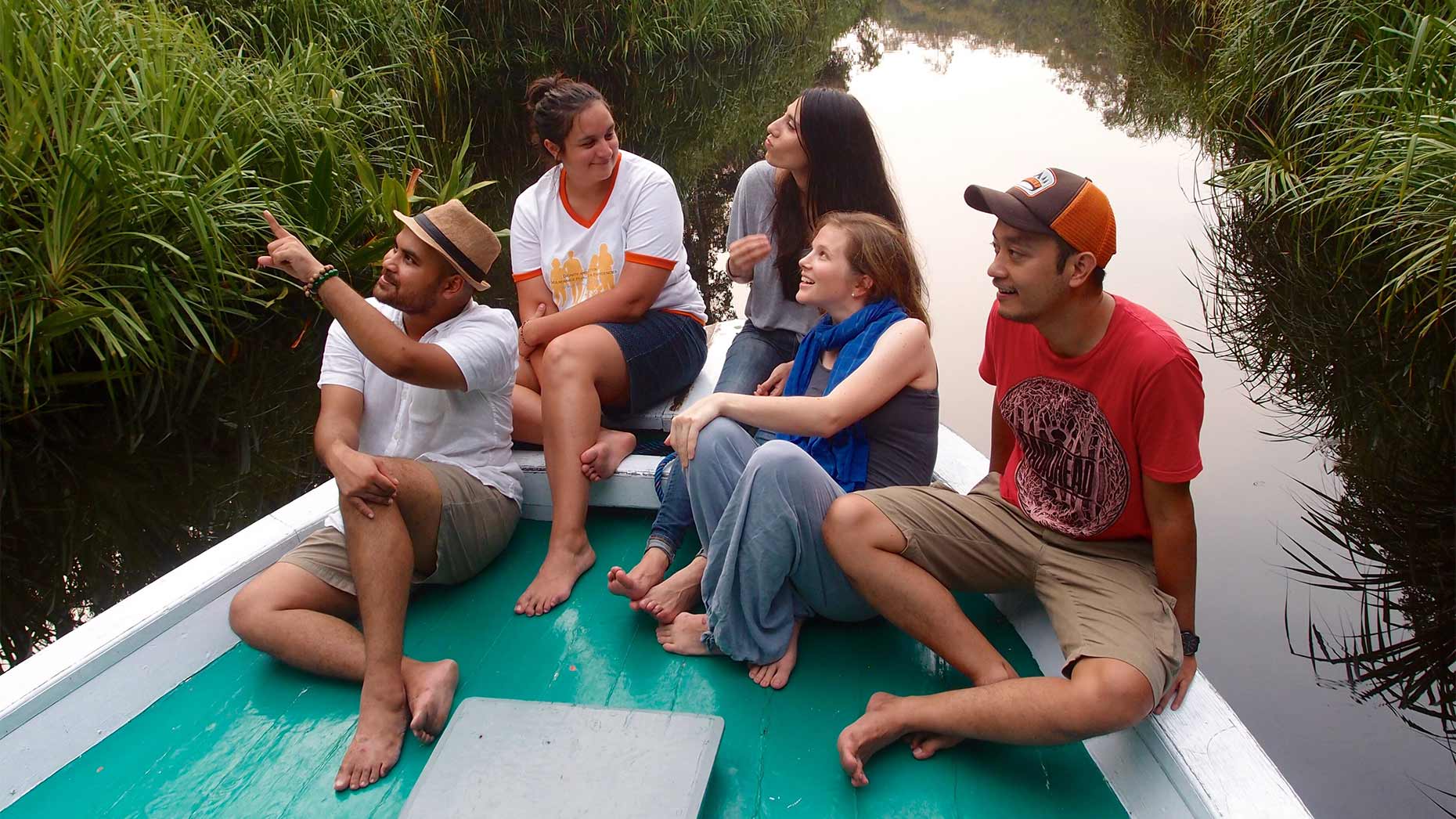 Five students floating down a river on a raft.
